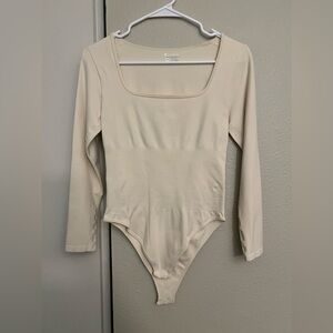 Beige long sleeve bodysuit